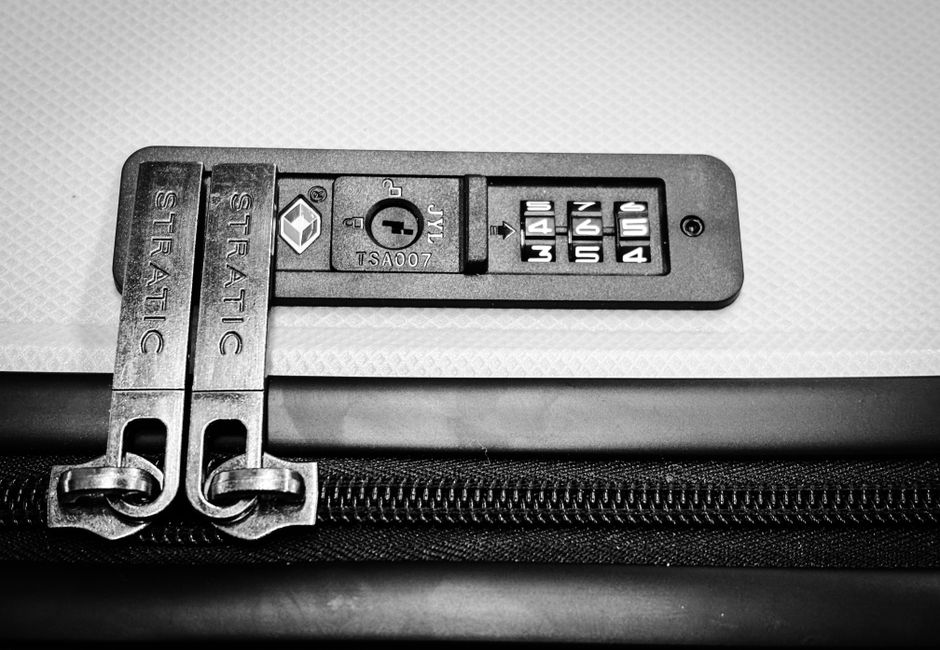 Close-up image of a TSA-compatible zipper lock on a suitcase, ensuring travel security.