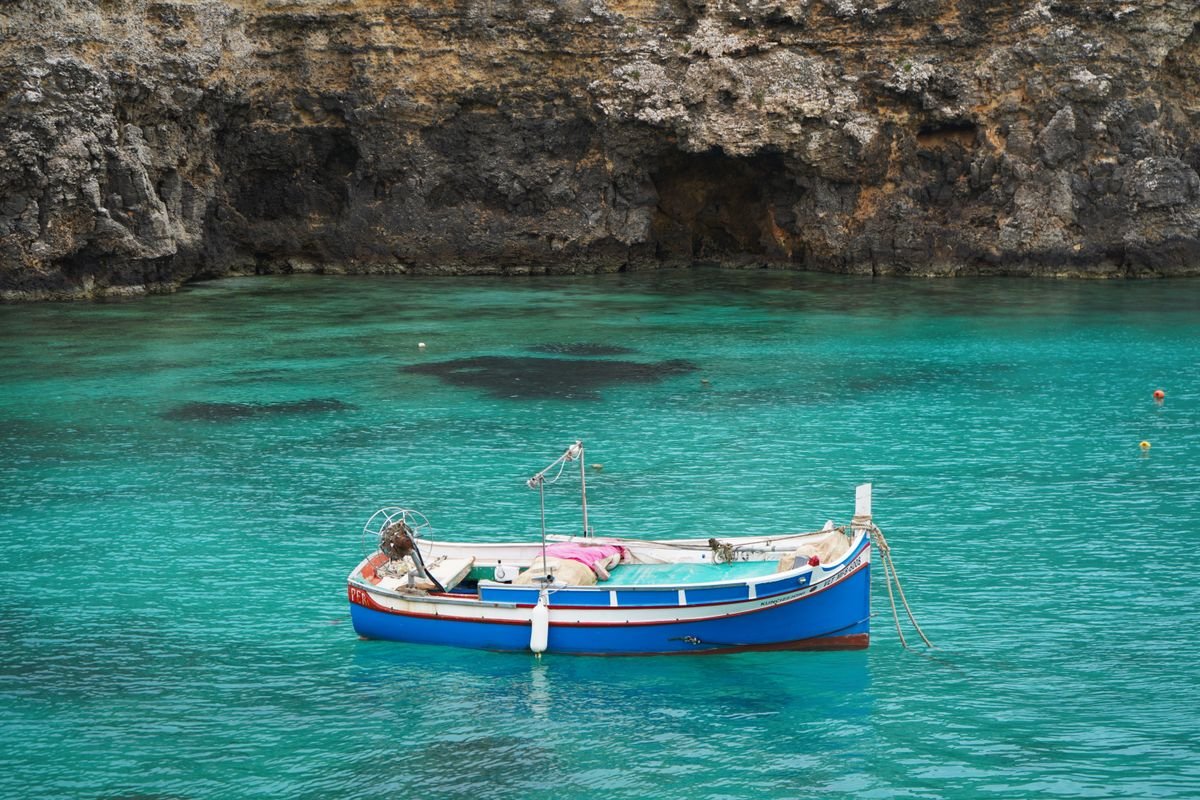 Barco de pesca en aguas cristalinas de Mellieha, Malta