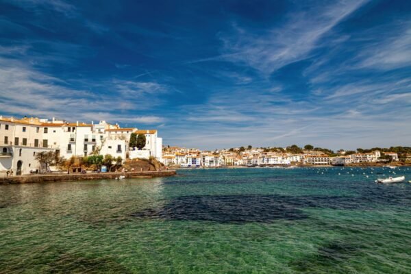Vista panorámica de Cadaqués con sus casas blancas y el Mediterráneo al atardecer