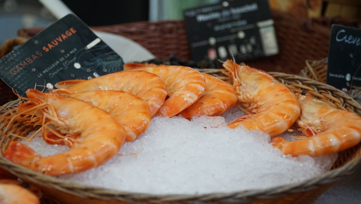 Langostinos frescos en puesto de mercado, marisco típico onubense