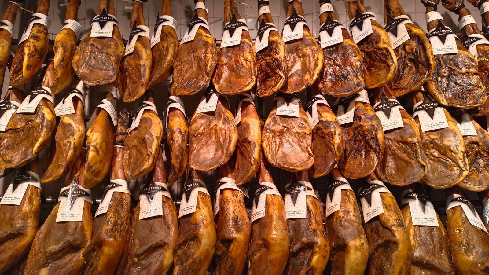 Jamón ibérico colgado en un puesto de mercado