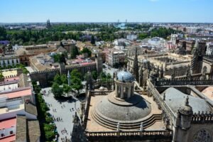 Stunning aerial view of Seville Cathedral with the cityscape of Seville, Spain on a sunny day.