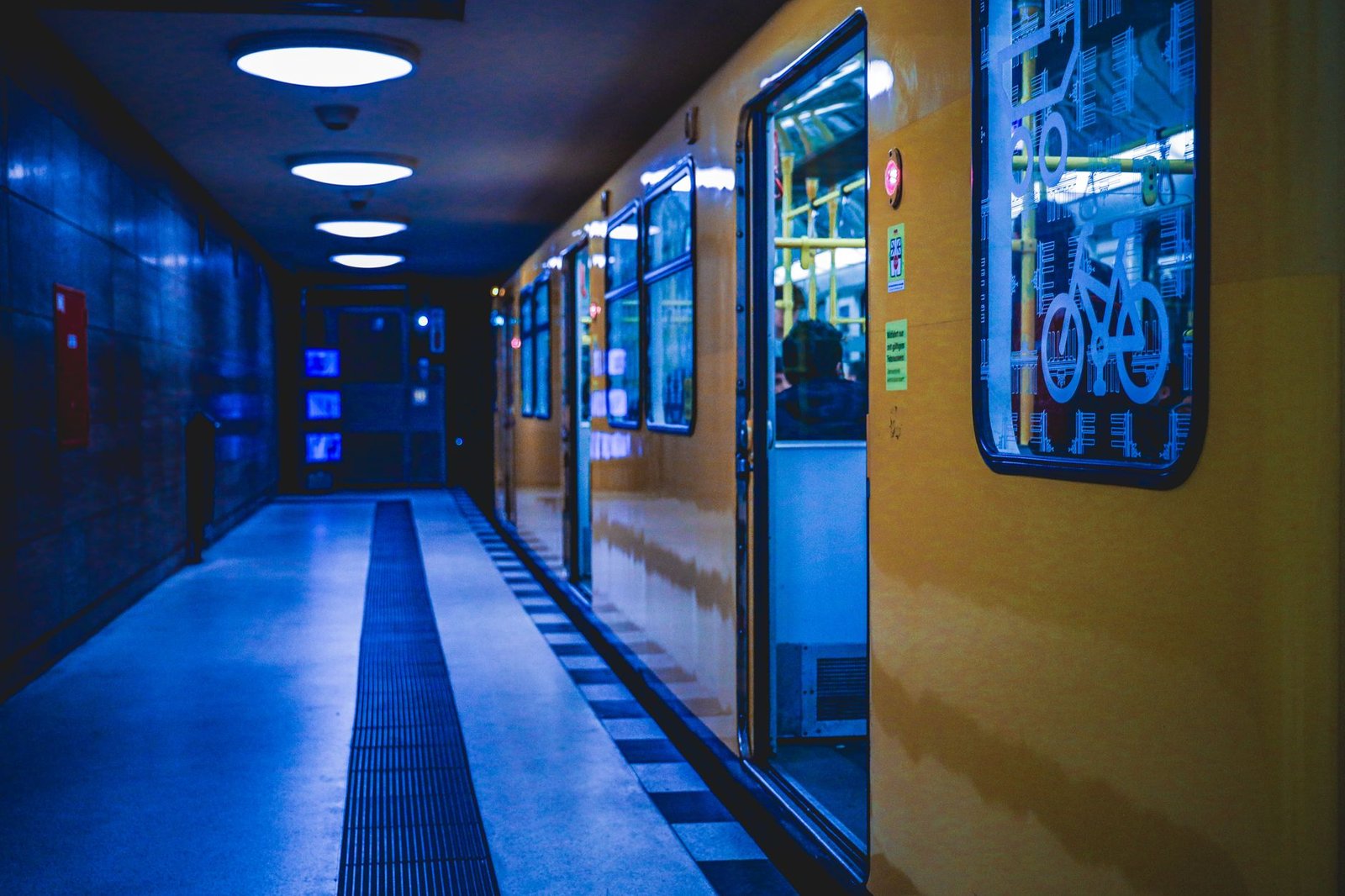 Tren amarillo del U-Bahn de Berlín en una estación iluminada de noche