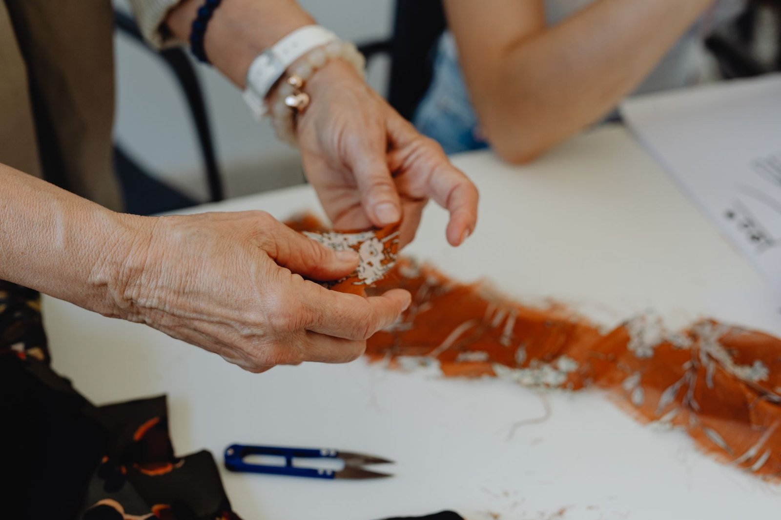 Manos elaborando encaje de bolillos, tradición artesanal de Camariñas