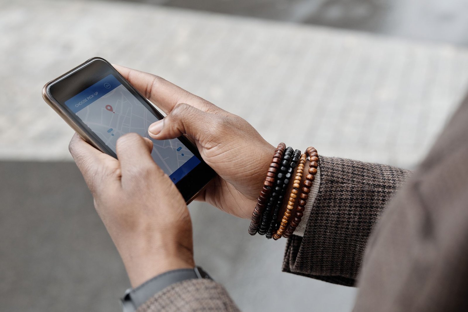 Manos consultando una aplicación GPS en el móvil durante una ruta al aire libre