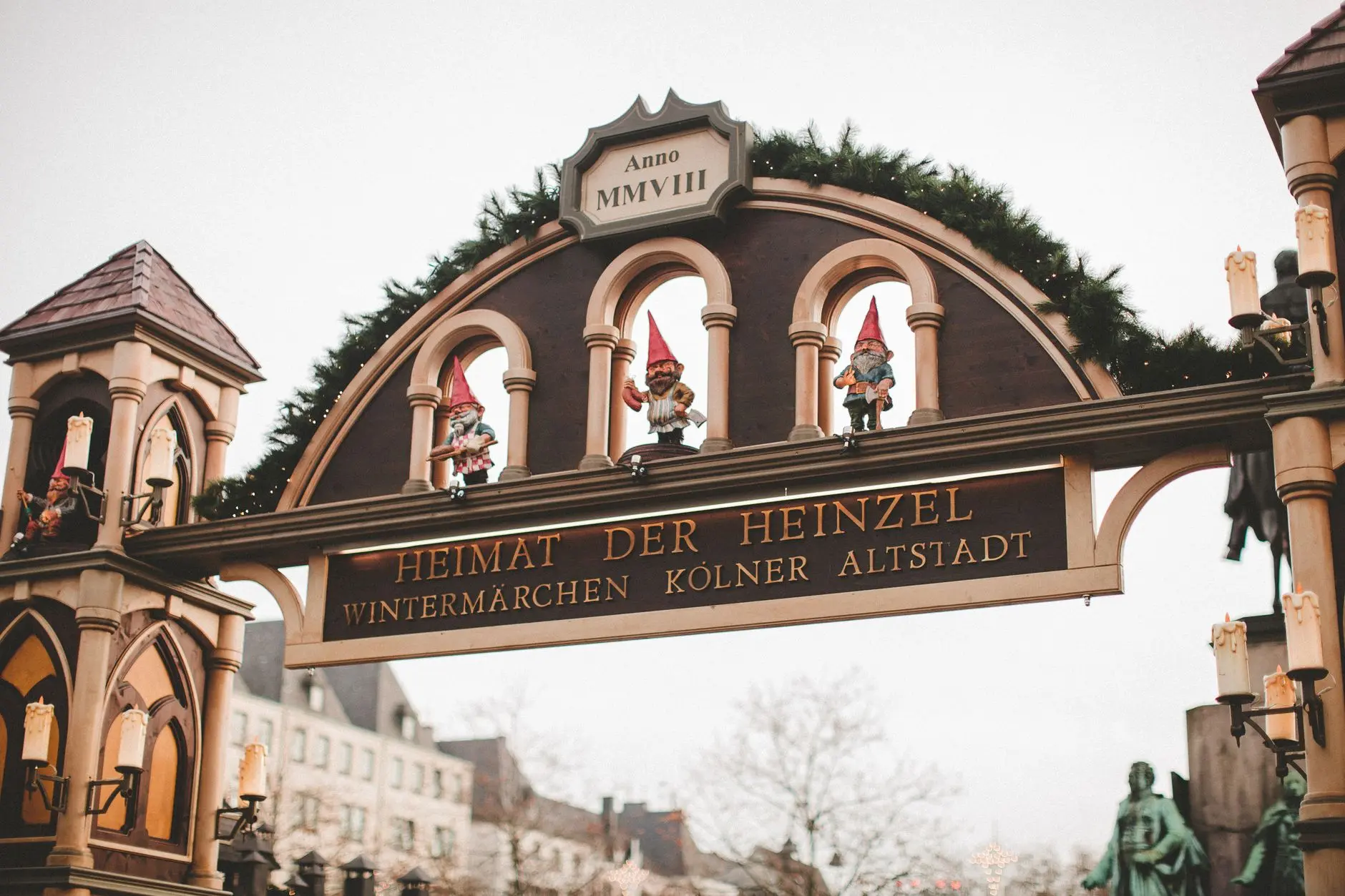 Entrada decorada de un mercado de Navidad de Colonia con esculturas de elfos